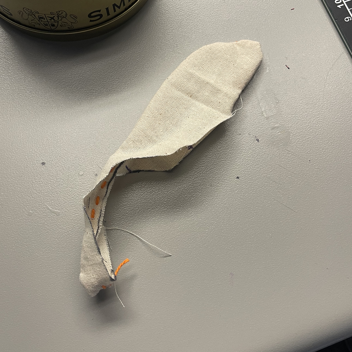 After sewing around the edges, I noticed that the strap was indeed too small to turn inside out all the way. After discussing with Nicole, we decided to pursue her design as it allowed more space than the wristband.