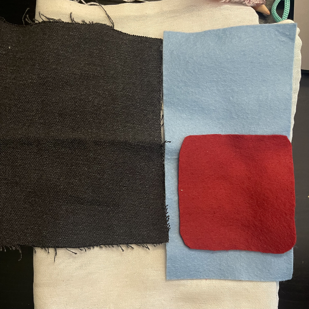 The fabric I used was: Heavy jean for the backing and the strap,red/blue felt for the border, and a very light mesh for the sensor pocket. I ended up using red felt instead of blue, I thought it would give a more medical vibe rather than the blue.
